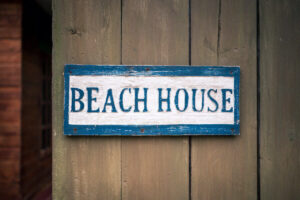 a wooden beach house sign